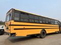 A yellow 2007 Freightliner B2 school bus with black trim features multiple windows on the side and a rear door
