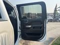 A 2017 Chevrolet Silverado 1500 with the front driver's door open showing the interior door panel and handle