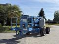 A blue 2012 Genie Z 45/25 boom lift with large tires and a platform raised above the body is parked on a concrete surface