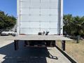 A 2020 Hino 338 truck with a lowered loading ramp at the back