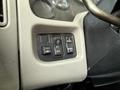 A control panel featuring four black buttons labeled with functions for lighting and panel control in a 2011 International 4300 vehicle