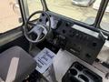 Interior view of a 2017 Freightliner MT45 showing the driver's seat steering wheel dashboard controls and a sign that says Thank You for serving you
