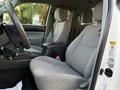Interior shot of a 2013 Toyota Tacoma showing front seats with gray fabric upholstery and a center console