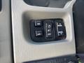 Buttons and controls on the dashboard of a 2008 International 4400 including mirror adjustment and lighting settings