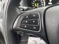 Close-up of the steering wheel controls of a 2021 Mercedes-Benz Metris featuring various buttons for navigation and settings