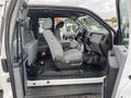 Interior of a 2015 Ford F-250 SD showing front seats and dashboard with grey fabric upholstery and a spacious cabin layout