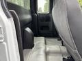 Interior view of the backseat area of a 2011 Chevrolet Colorado showing fabric seats and flooring without any passengers or items