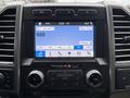 Interior dashboard of a 2018 Ford F-150 featuring a central touchscreen display with audio and climate controls