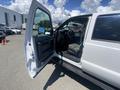 A white 2016 Ford F-350 Super Duty with an open driver's door showing the interior including the seats and dashboard