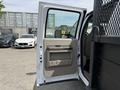 A 2008 Ford F-550 with an open passenger door showcasing a beige interior handle and panel