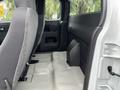 Interior view of a 2011 Chevrolet Colorado showcasing the rear seating area with fabric upholstered seats and a clean floor space