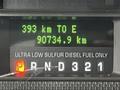 Dashboard display of a 2009 Ford F-550 showing remaining distance to empty as 393 km and total distance traveled as 90784.9 km with fuel type indicator for ultra low sulfur diesel fuel only