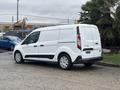 A white 2019 Ford Transit Connect van parked with sliding side door and rear doors closed, showcasing its compact design and cargo space