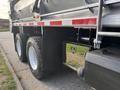 2013 Freightliner 114SD with a black and silver body heavy-duty truck showing large rear tires and a metal tool compartment on the side