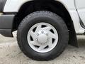 Close-up of a 2008 Ford Econoline wheel featuring a silver five-spoke rim mounted with a rugged all-terrain tire showcasing detailed tread pattern