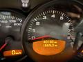 A dashboard of a 2003 Porsche 911 displaying speedometer and odometer readings with the speedometer marked at zero and the odometer reading 40180 kilometers