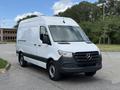 A 2022 Mercedes-Benz Sprinter van in white with a black front bumper and side panels parked with its front facing the camera