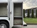 A 2017 Ford F-350 SD with an open cargo area showing empty shelves and a clean interior space