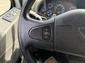 A close-up of the steering wheel of a 2011 International 4300 with a cruise control switch labeled ON and OFF