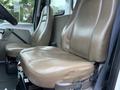 Interior of a 2004 Sterling LT9500 truck featuring two beige leather seats with a minimalistic design