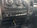 The interior dashboard controls of a 2016 RAM 5500 featuring buttons for auxiliary lights air conditioning and various settings