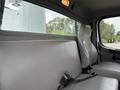 Interior view of the passenger cabin of a 2021 Freightliner M2 106 featuring a gray bench seat and a seatbelt on the right