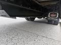 A 2022 Freightliner B2 truck partially visible from underneath showcasing its tires and undercarriage components