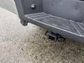 Close-up of a 2008 Ford F-250 SD receiver hitch with rain droplets on it