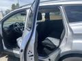 Interior of a 2015 Ford Escape with open front and rear doors showing seats and dashboard