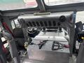 The interior of a 2006 E-One Typhoon with a dashboard featuring air vents and a metal storage compartment with straps on top