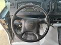 A 2011 Workhorse W62 steering wheel with the company logo visible and various dashboard gauges in the background