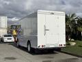 A 2017 Freightliner MT45 delivery truck with a plain white exterior and a boxy shape parked in a lot