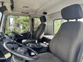 Interior of a 2012 Autocar Xpert showing two large seats in the cab with a steering wheel and control panel visible