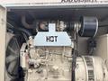 A 2005 Katolight SED60FPJ4 generator featuring exposed engine components air intake and a warning label indicating hot on a protective panel
