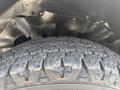 Close-up of a tire with a rugged tread pattern mounted on a 2020 Chevrolet Express wheel