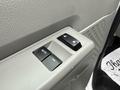 Window control panel with two buttons labeled AUTO and another for locking or unlocking the doors on a 2024 Ford E-450