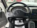Steering wheel of a 2013 International Workstar 7500 with controls and dashboard gauges visible behind