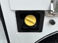 Close-up of a fuel inlet on a 2013 Ford F-250 SD with a yellow cap visible inside a black rectangular frame