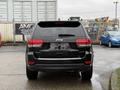 A black 2019 Jeep Grand Cherokee is shown from the rear with the Jeep logo visible and the words Limited and 4x4 displayed on the back