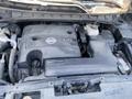 Close-up of the engine bay of a 2017 Nissan Murano featuring a V6 engine cover and various components including the battery and fluid reservoir