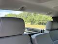 Interior view of a 2016 Chevrolet Silverado 2500HD showing the backseat headrests and the window looking out onto greenery
