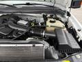 2008 Ford F-350 engine with a large air intake system and various components including a coolant reservoir and intercooler