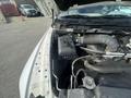 An open hood of a 2012 RAM 2500 showcasing the engine compartment with visible engine components and hoses