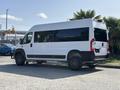A white 2022 RAM Promaster 350 van with tinted windows and sleek design parked on a gravel surface