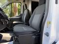 Interior view of a 2022 Ford Transit showing the driver's seat and passenger seat both featuring dark gray upholstery and a modern design