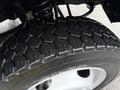 Close-up of a rugged tire on a 2006 Ford F-450 SD showcasing its deep tread pattern designed for traction and durability