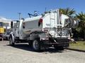 A 2008 International DuraStar truck with a white tank body and a hose attachment on the side