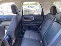 2023 Ford Bronco Sport interior featuring a rear seating area with two seats upholstered in dark fabric and a center console with armrest