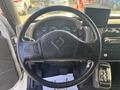 A steering wheel of a 2008 International 4400 with various dashboard gauges and controls visible next to it
