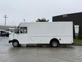 A white 2012 Ford Econoline delivery van viewed from the side with a blank exterior and a small door on the side